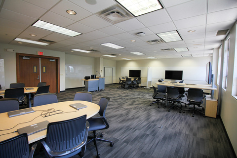 Image of classroom with tables and computers