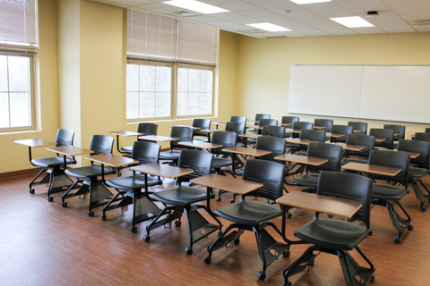 Image of classroom filled with student desks