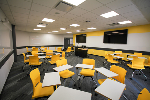 image of classroom with bright yellow tablet arm chairs